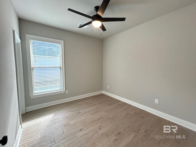 spare room with ceiling fan and light hardwood / wood-style flooring