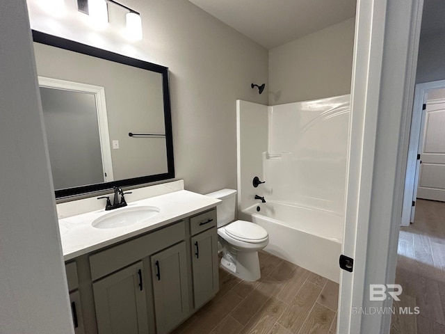 full bathroom featuring shower / tub combination, toilet, vanity, and hardwood / wood-style flooring