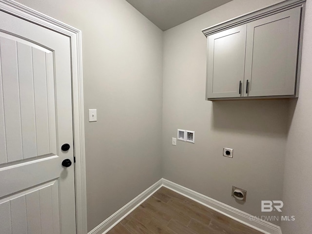 laundry area with hookup for an electric dryer, dark hardwood / wood-style floors, cabinets, and hookup for a washing machine