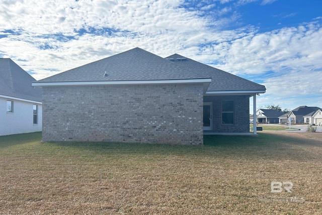 back of house featuring a lawn and a patio