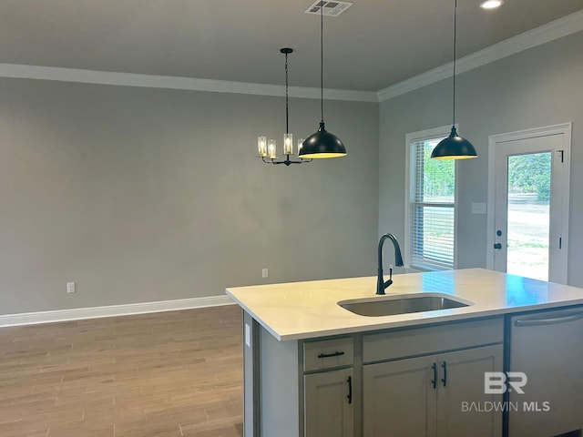 kitchen with stainless steel dishwasher, sink, pendant lighting, a center island with sink, and light hardwood / wood-style flooring