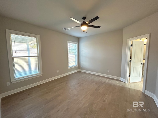 unfurnished room featuring light hardwood / wood-style flooring and ceiling fan