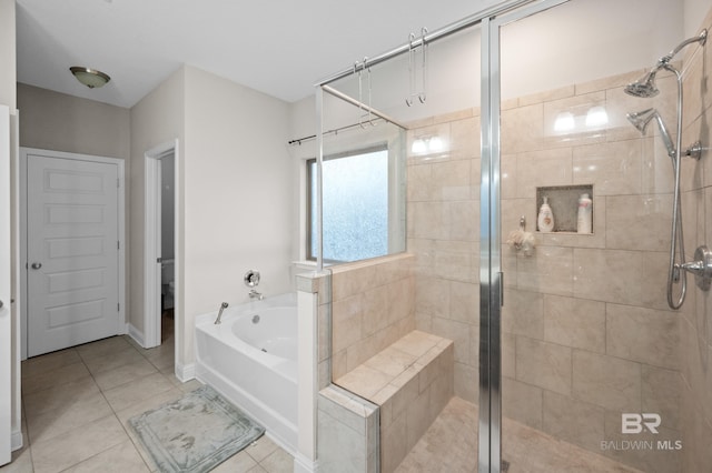 bathroom featuring tile patterned floors and independent shower and bath