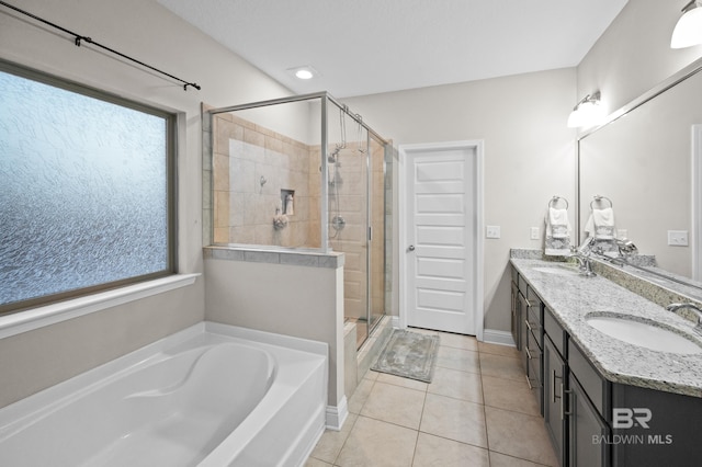 bathroom featuring tile patterned flooring, vanity, a wealth of natural light, and shower with separate bathtub