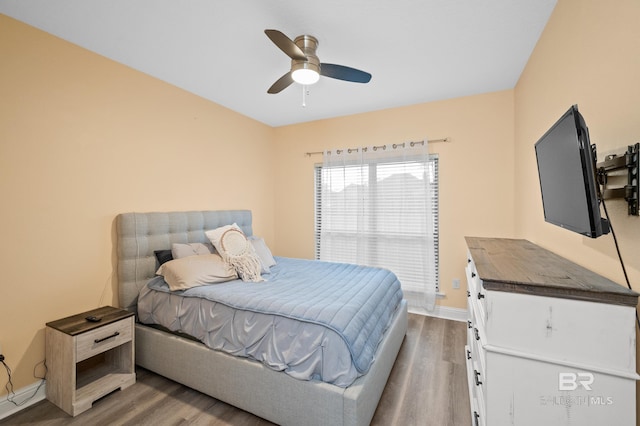 bedroom with ceiling fan and wood-type flooring