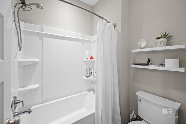 bathroom featuring shower / bath combination with curtain and toilet