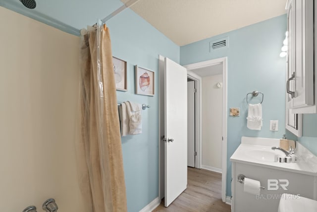 bathroom with hardwood / wood-style flooring and vanity