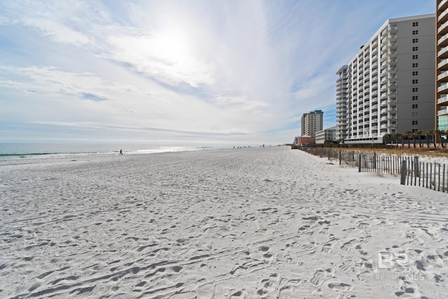 surrounding community featuring a water view and a view of the beach