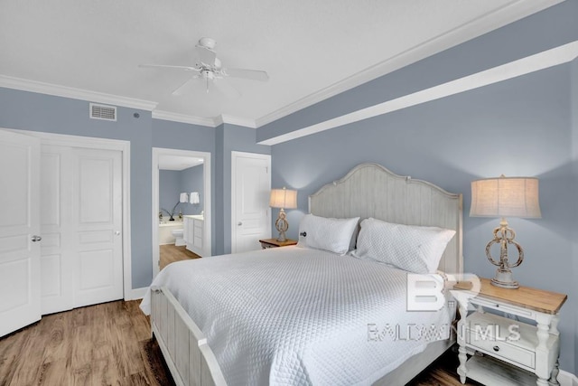 22984 Perdido Beach Blvd Unit 52D, Orange Beach, AL 36561 - bedroom with connected bathroom, crown molding, wood finished floors, and visible vents