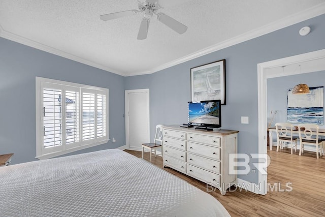 22984 Perdido Beach Blvd Unit 52D, Orange Beach, AL 36561 - bedroom with wood finished floors, a textured ceiling, crown molding, and baseboards