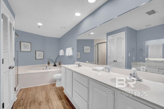 22984 Perdido Beach Blvd Unit 52D, Orange Beach, AL 36561 - full bath with a sink, double vanity, wood finished floors, a closet, and a garden tub