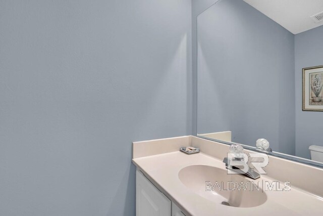 22984 Perdido Beach Blvd Unit 52D, Orange Beach, AL 36561 - bathroom featuring toilet, vanity, and visible vents