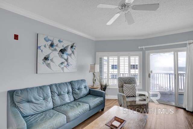 22984 Perdido Beach Blvd Unit 52D, Orange Beach, AL 36561 - living area with wood finished floors, a textured ceiling, crown molding, and a ceiling fan