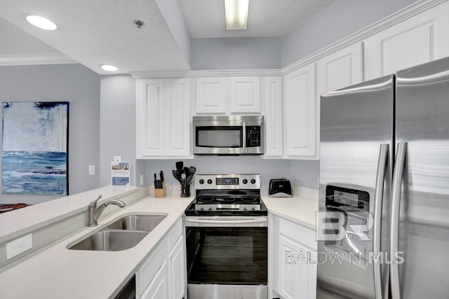 22984 Perdido Beach Blvd Unit 52D, Orange Beach, AL 36561 - kitchen featuring light countertops, white cabinets, stainless steel appliances, and a sink