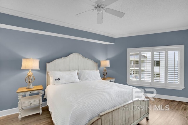 22984 Perdido Beach Blvd Unit 52D, Orange Beach, AL 36561 - bedroom with wood finished floors, crown molding, baseboards, and a ceiling fan
