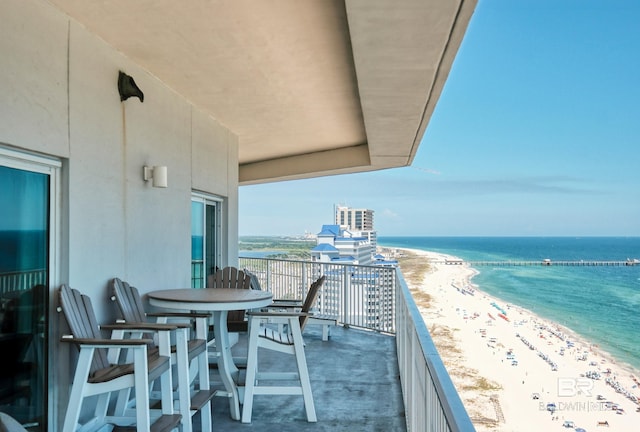 balcony with a water view and a beach view