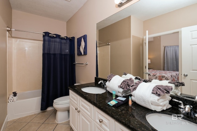 full bathroom featuring shower / bath combo, vanity, a textured ceiling, tile patterned flooring, and toilet