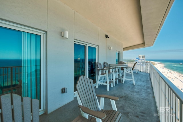 balcony with a water view and a beach view