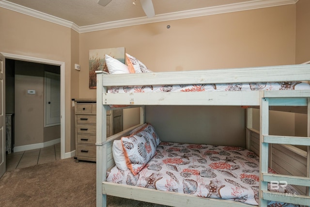 carpeted bedroom featuring ceiling fan and crown molding