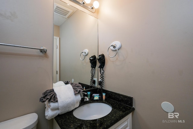 bathroom with vanity and toilet