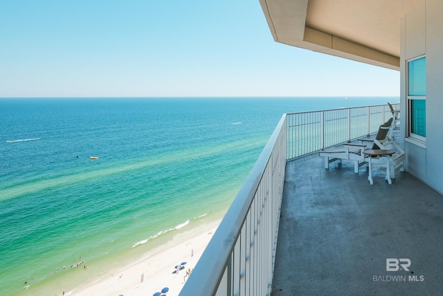 balcony with a view of the beach and a water view