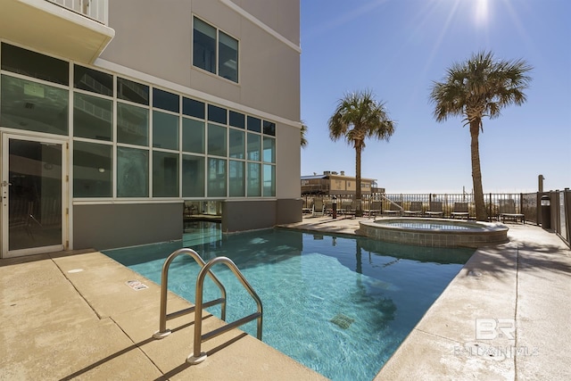 view of swimming pool with a patio area and a community hot tub