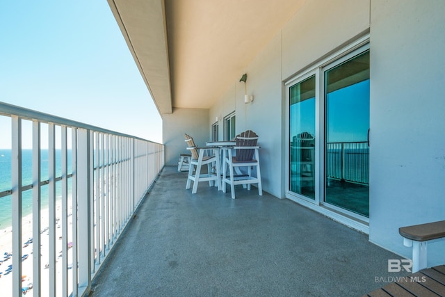 balcony with a water view and a beach view