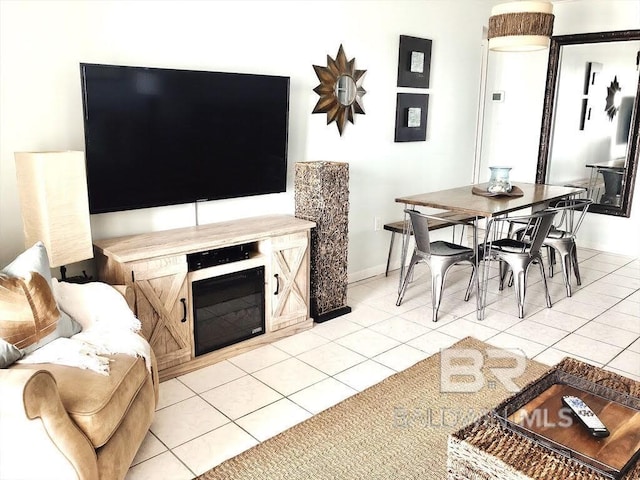 living room featuring baseboards and light tile patterned flooring