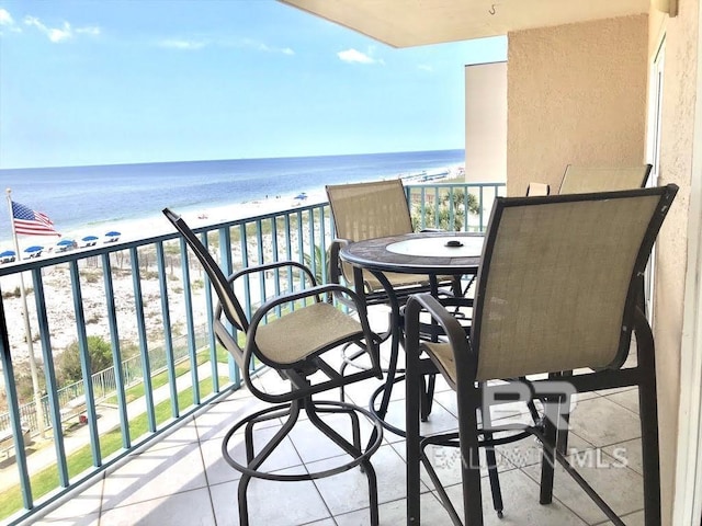 balcony with a water view and a beach view