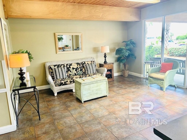 living area with wooden ceiling and baseboards