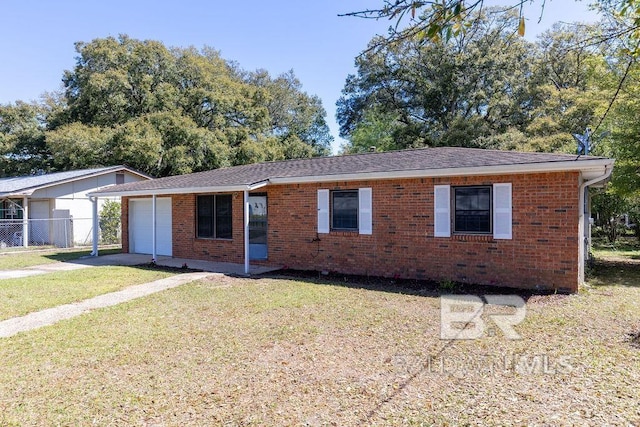 ranch-style home with brick siding, a front yard, an attached garage, and fence