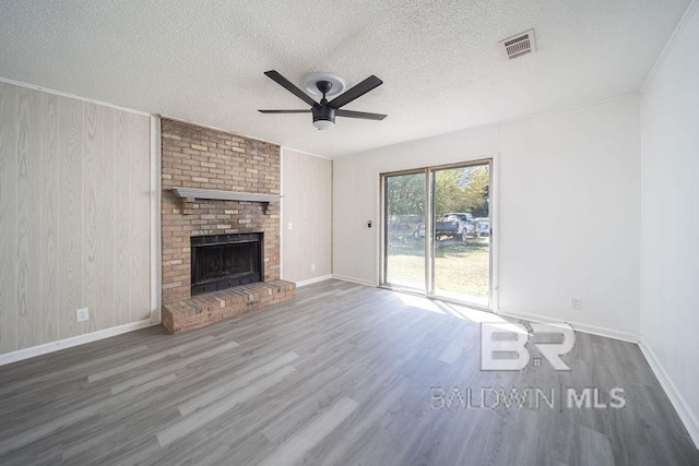 unfurnished living room featuring visible vents, ceiling fan, and wood finished floors