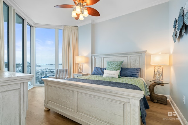 28250 Canal Rd Unit 101, Orange Beach, AL 36561 - bedroom with expansive windows, multiple windows, crown molding, and light wood finished floors