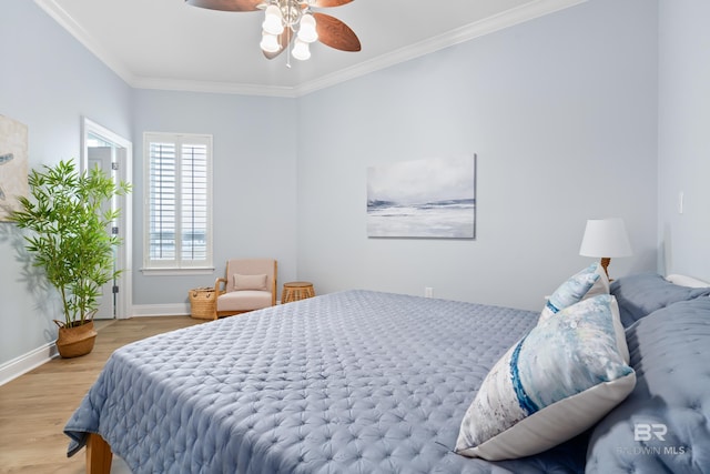 28250 Canal Rd Unit 101, Orange Beach, AL 36561 - bedroom featuring a ceiling fan, crown molding, baseboards, and wood finished floors