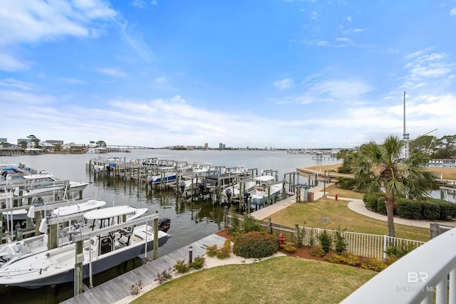 28250 Canal Rd Unit 101, Orange Beach, AL 36561 - view of dock featuring a yard, a water view, fence, and boat lift
