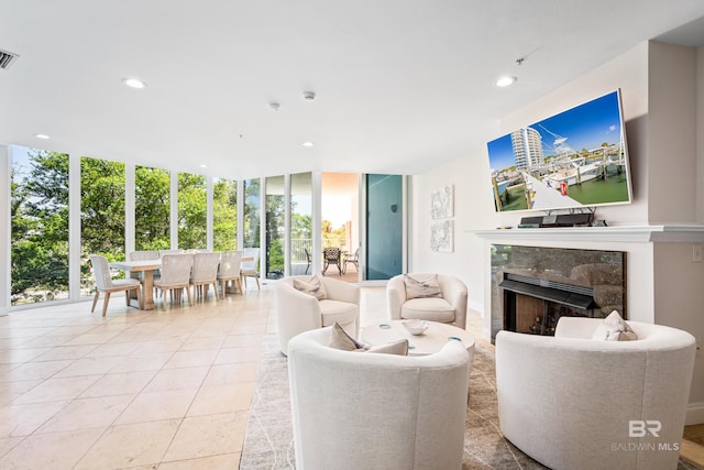 28250 Canal Rd Unit 101, Orange Beach, AL 36561 - living area with light tile patterned floors, recessed lighting, visible vents, a high end fireplace, and expansive windows