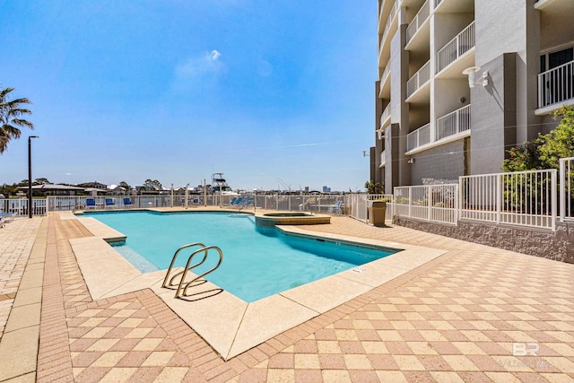 28250 Canal Rd Unit 101, Orange Beach, AL 36561 - view of pool featuring a patio, fence, and a pool with connected hot tub