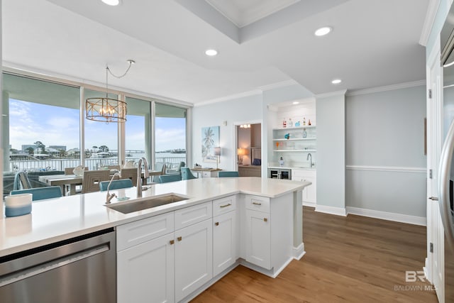 28250 Canal Rd Unit 101, Orange Beach, AL 36561 - kitchen with stainless steel dishwasher, a sink, light wood-style flooring, and crown molding