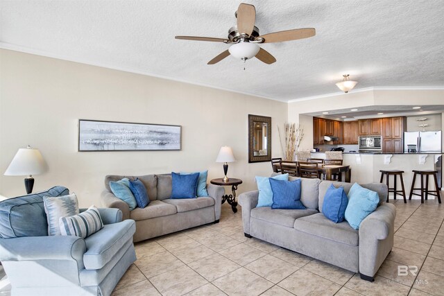 tiled living room featuring ceiling fan, a textured ceiling, and ornamental molding