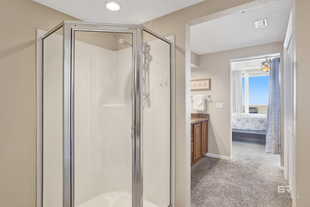 bathroom with ceiling fan, an enclosed shower, and vanity