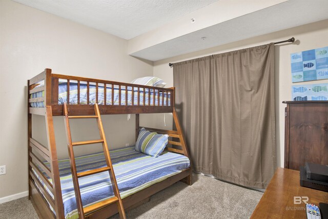 bedroom featuring a textured ceiling and carpet floors