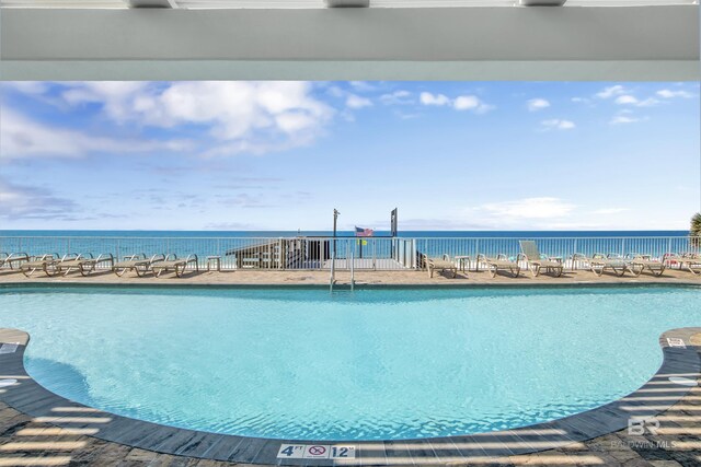 view of pool with a water view