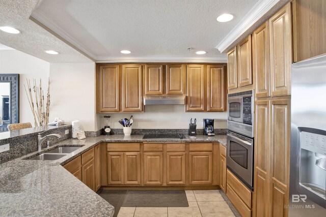 kitchen featuring appliances with stainless steel finishes, ornamental molding, sink, a textured ceiling, and light tile patterned flooring