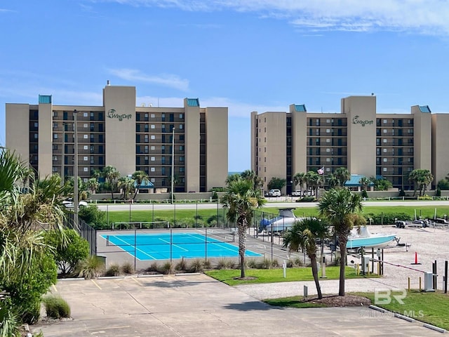 view of swimming pool with tennis court