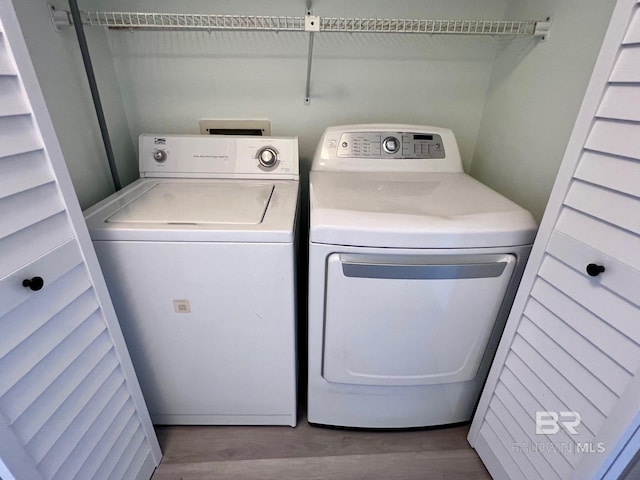 washroom featuring washer and dryer and wood-type flooring