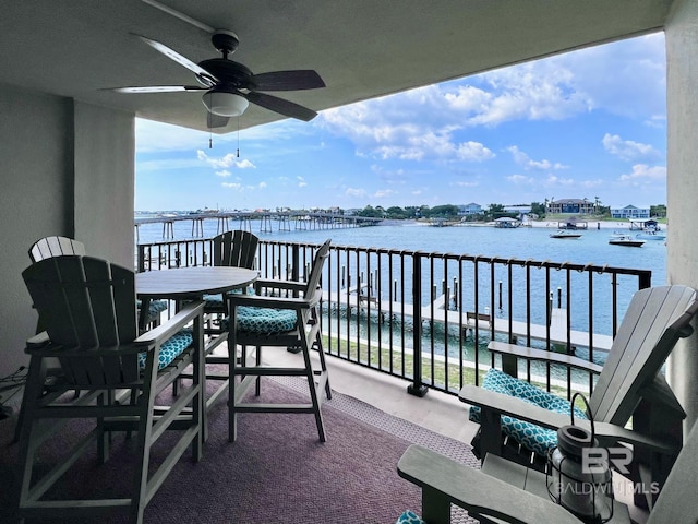 balcony with ceiling fan and a water view