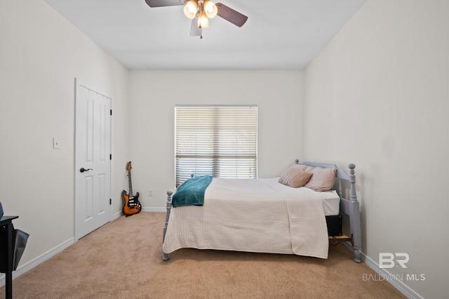 carpeted bedroom featuring ceiling fan and baseboards