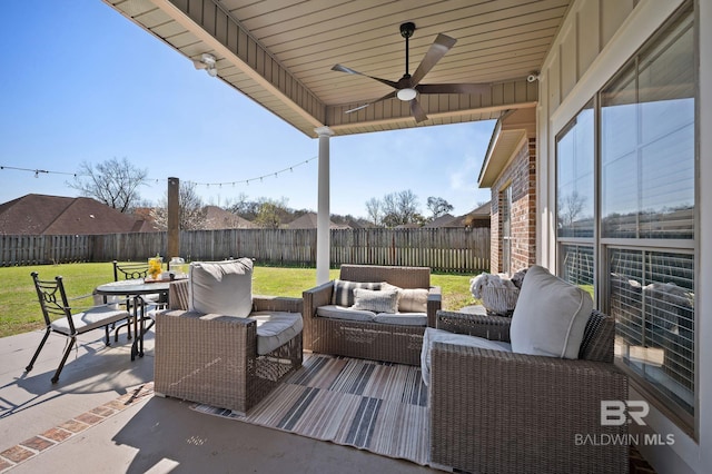 view of patio featuring ceiling fan, outdoor dining area, a fenced backyard, and an outdoor hangout area