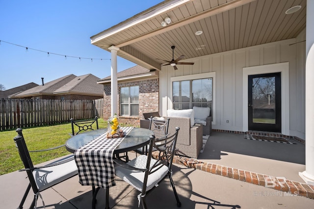 view of patio / terrace with outdoor dining area, ceiling fan, and fence