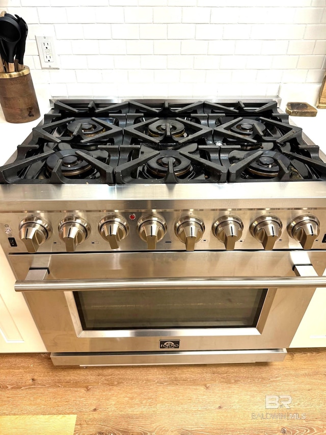 details with backsplash and high end stainless steel range